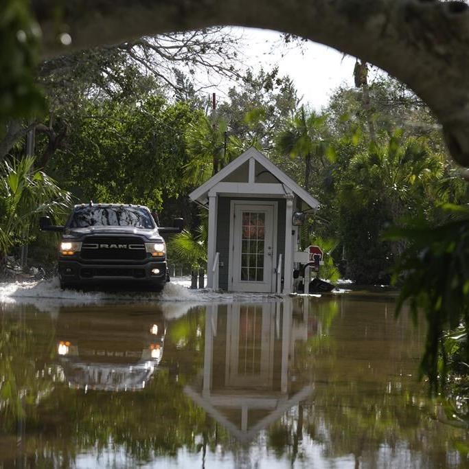 Residents slog through flooded streets, clear debris after Hurricane Milton tore through Florida